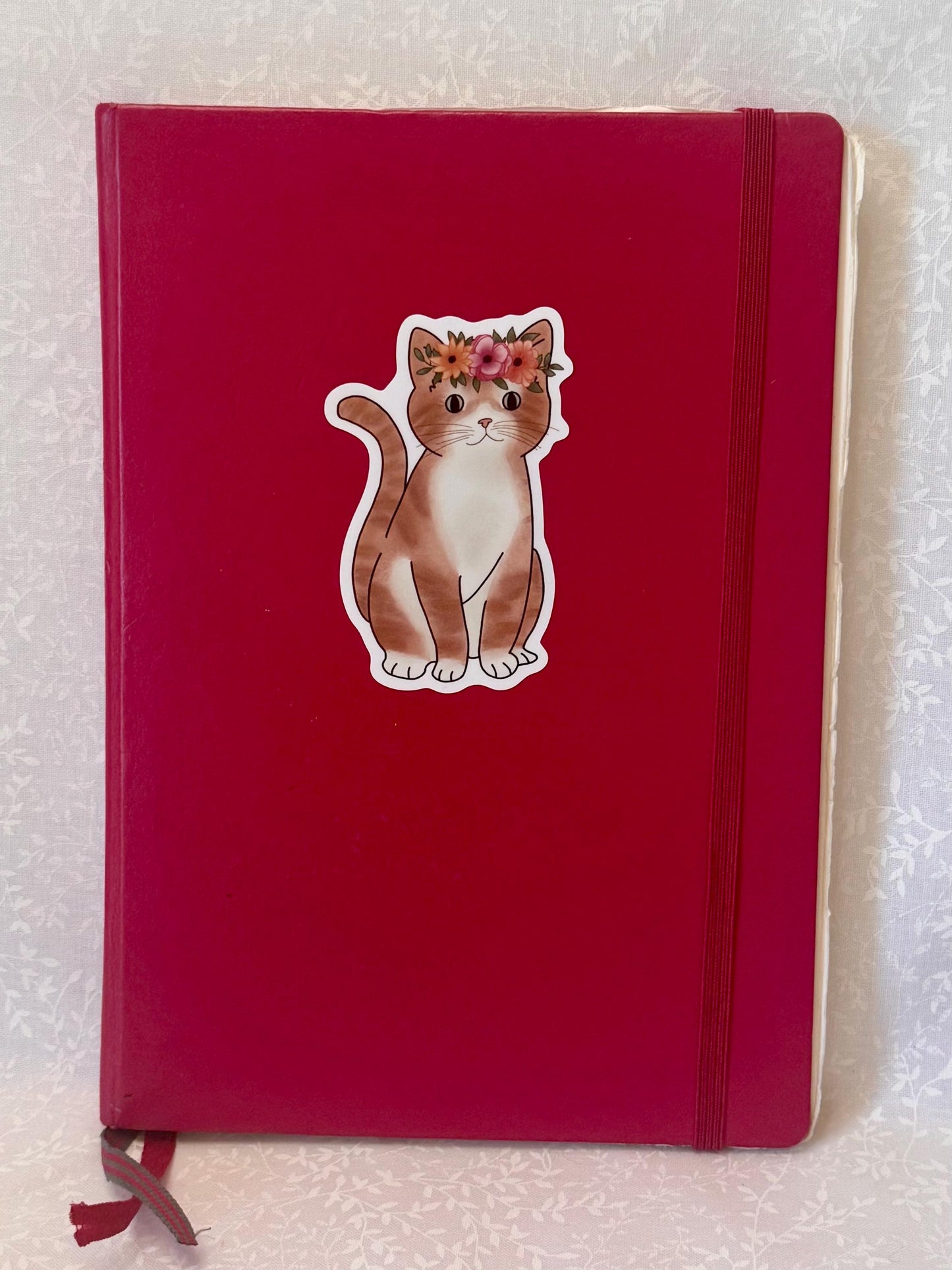 Orange tabby cat with flower crown | Sticker
